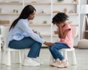 Therapist comforting a young girl during a grief counseling session.