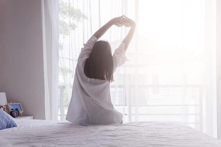 Woman waking up and stretching