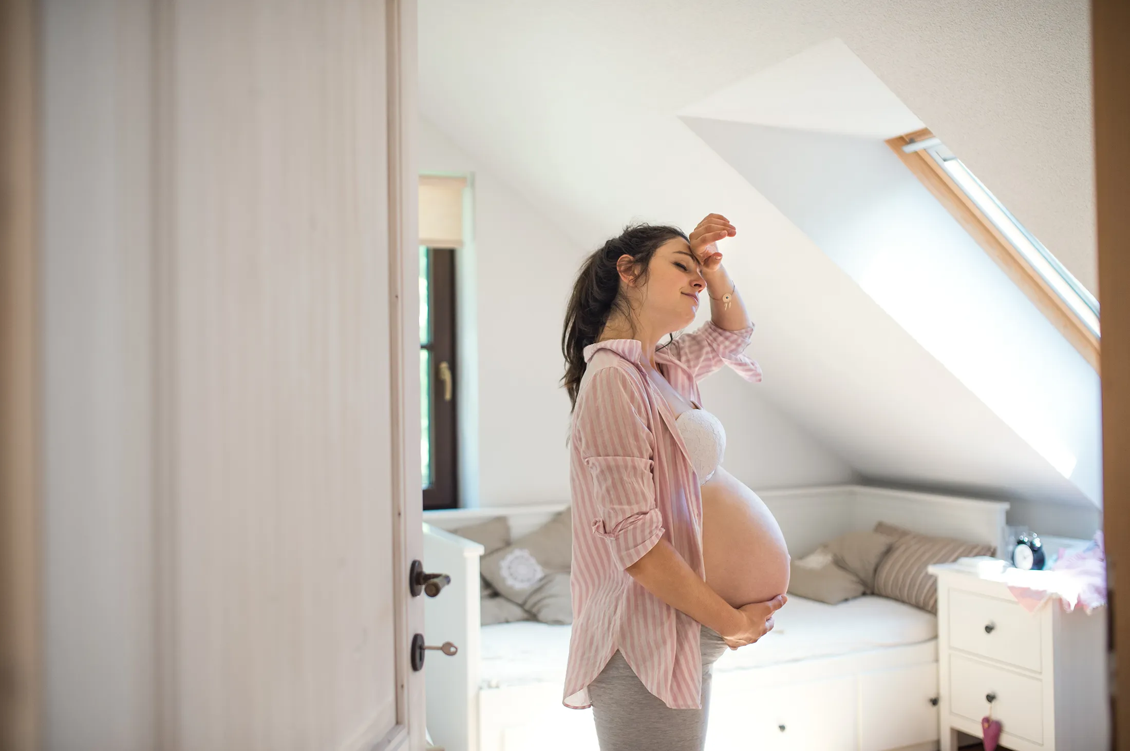 Pregnant woman feeling overwhelmed at home, representing perinatal mental health and therapy support for expectant mothers