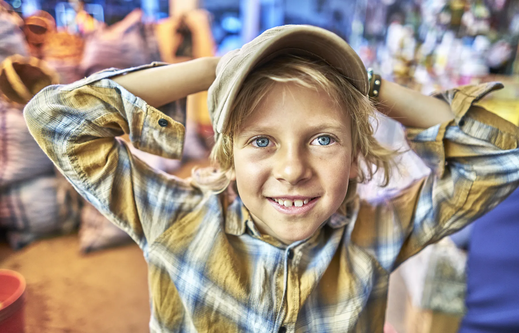 Smiling young boy in a colorful setting, symbolizing childhood joy and the importance of family mental health services during Mental Health Awareness Month.